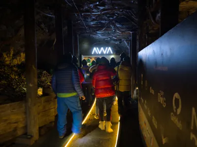 People standing in front of the entrance to the Arctic World Archive.